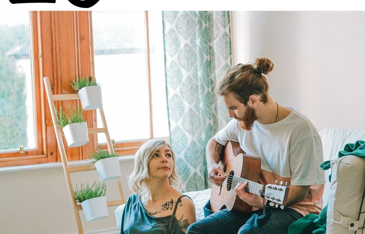 Couple at home with a guitar and coffee, overlaid with the text 25 at-home date nights for a Canadian Mom Blog post.