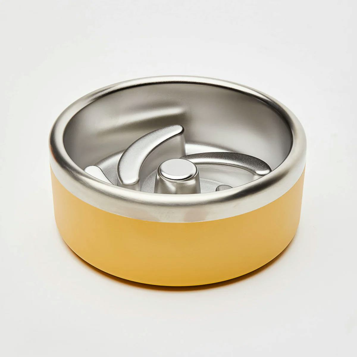 Yellow stainless steel dog puzzle bowl with raised metal fins, designed as a slow feeder to reduce gulping and support healthier digestion.