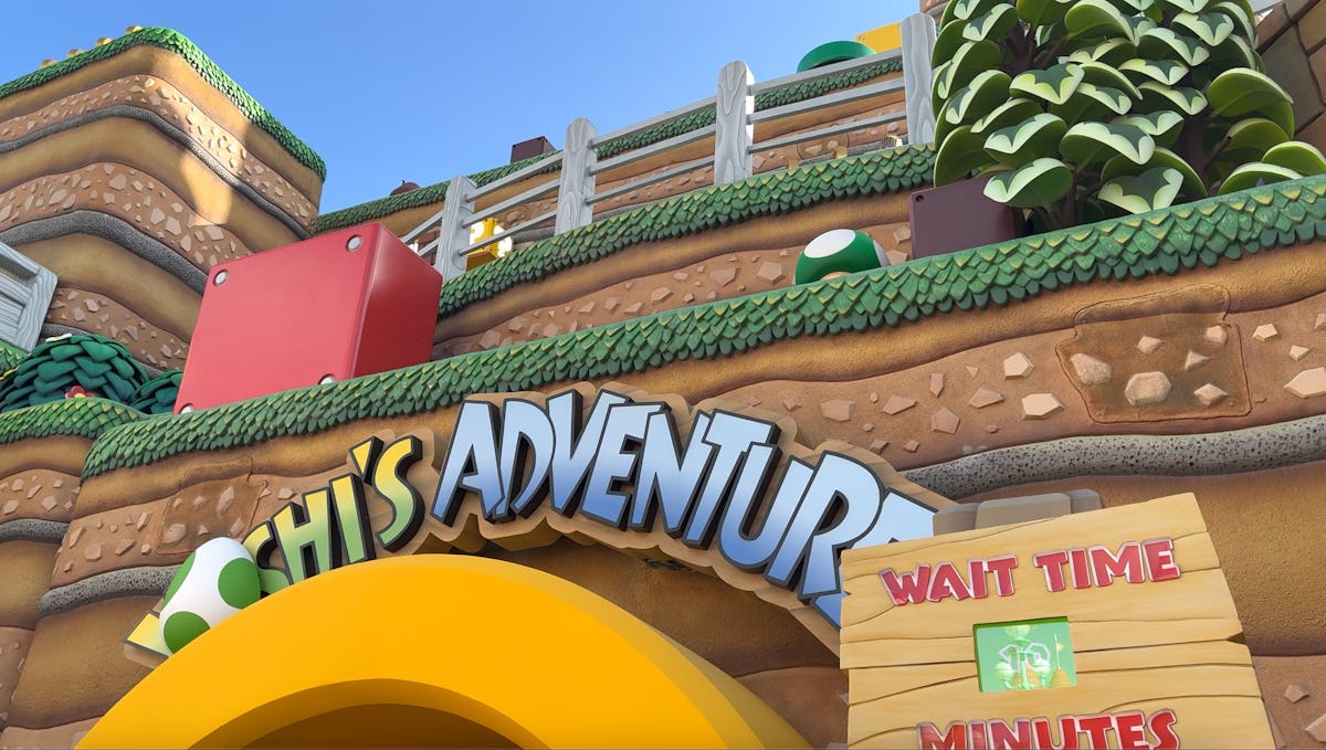 Yoshi's Adventure entrance in Super Nintendo World at Universal Epic Universe with colorful Mario-themed scenery and wait time sign.