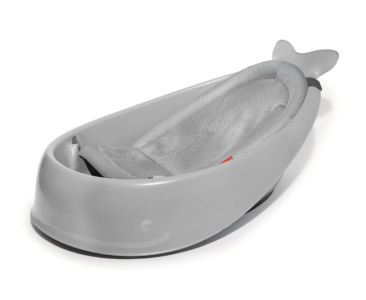 Gray whale-shaped baby bathtub with a mesh newborn sling, shown on a white background as a practical baby registry bath essential.
