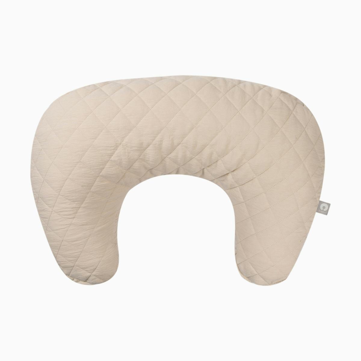 Beige quilted nursing pillow with a curved U shape and soft padded cover, shown on a plain white background for a baby registry guide.