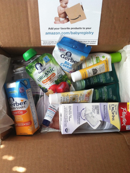 Open cardboard box containing baby product samples, including Gerber items and an Amazon Baby Registry insert.