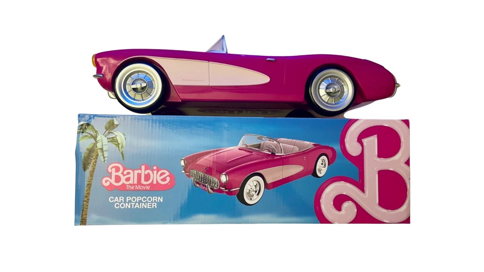 Pink toy car popcorn container displayed on its blue retail box with readable Barbie movie text
