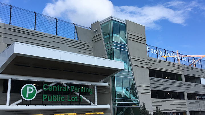 Parking garage entrance with Central Parking Public Lot 1 sign and Foothills Medical Centre text above