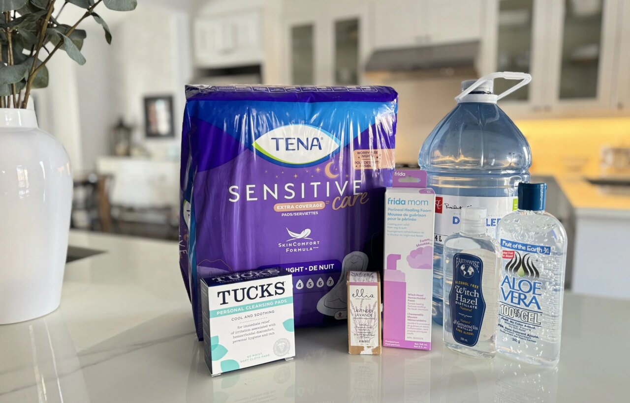 Perineal care supplies on a counter, including TENA pads, Tucks pads, witch hazel, aloe gel, and water