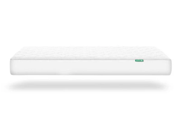 White crib-style mattress floating on a white background with a soft shadow below