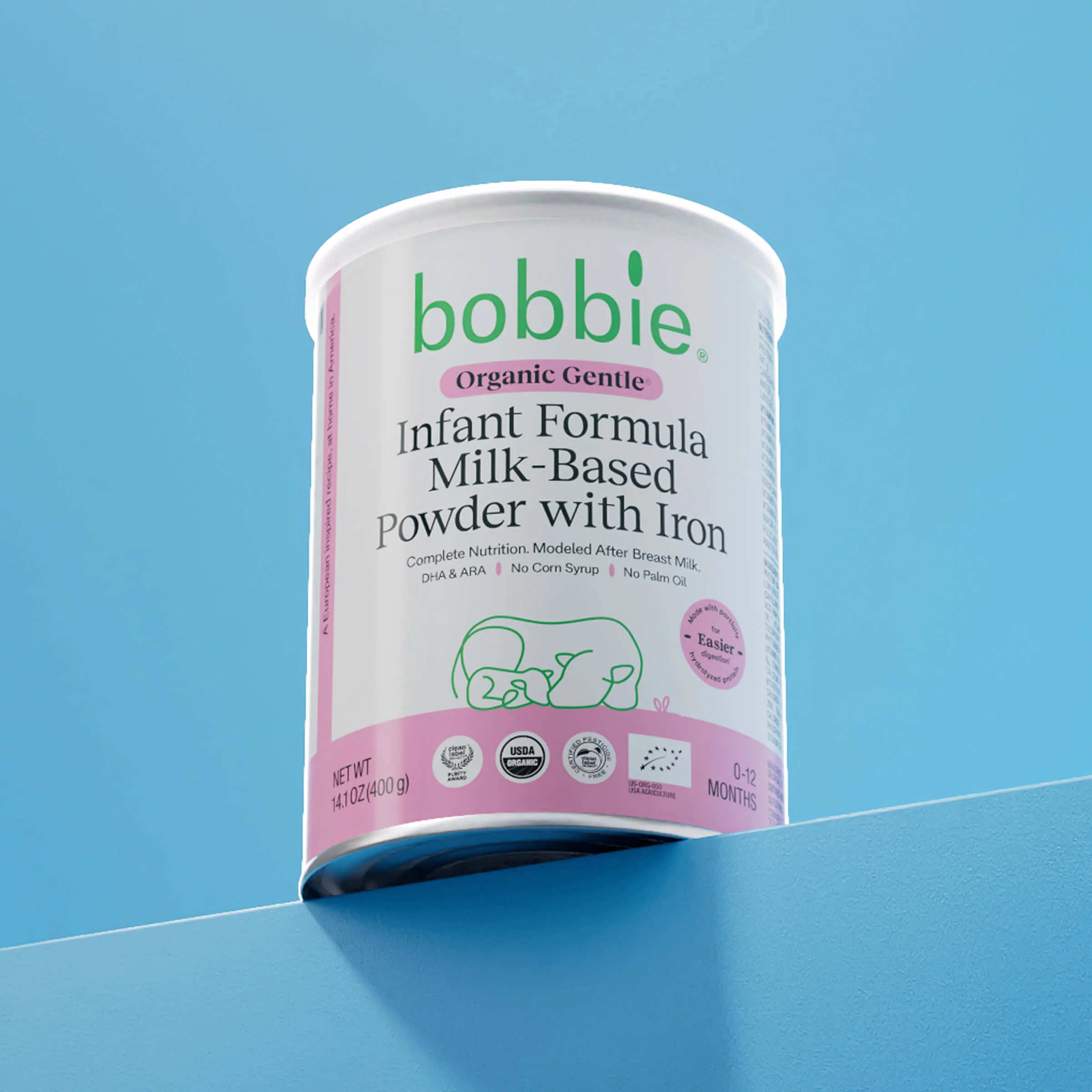 Can of Bobbie Organic Gentle infant formula on a bright blue surface and background